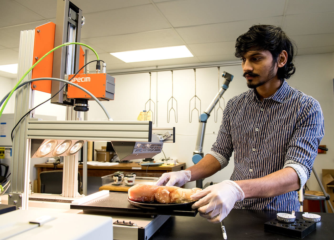 HIGH-TECH VIEW — Graduate assistant Chaitanya Kumar Reddy Pallerla investigates the use of hyperspectral imaging to detect a defect in chicken meat. (U of A System Division of Agriculture photo by Fred Miller)