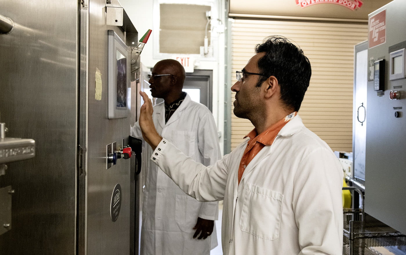 MICROWAVES — Kaushik Luthra, post-doctoral research associate, right, and Griffiths Atungulu, director of the Arkansas Rice Processing Program, operate a pilot-scale industrial microwave for drying rice. (U of A System Division of Agriculture photo by Fred Miller)