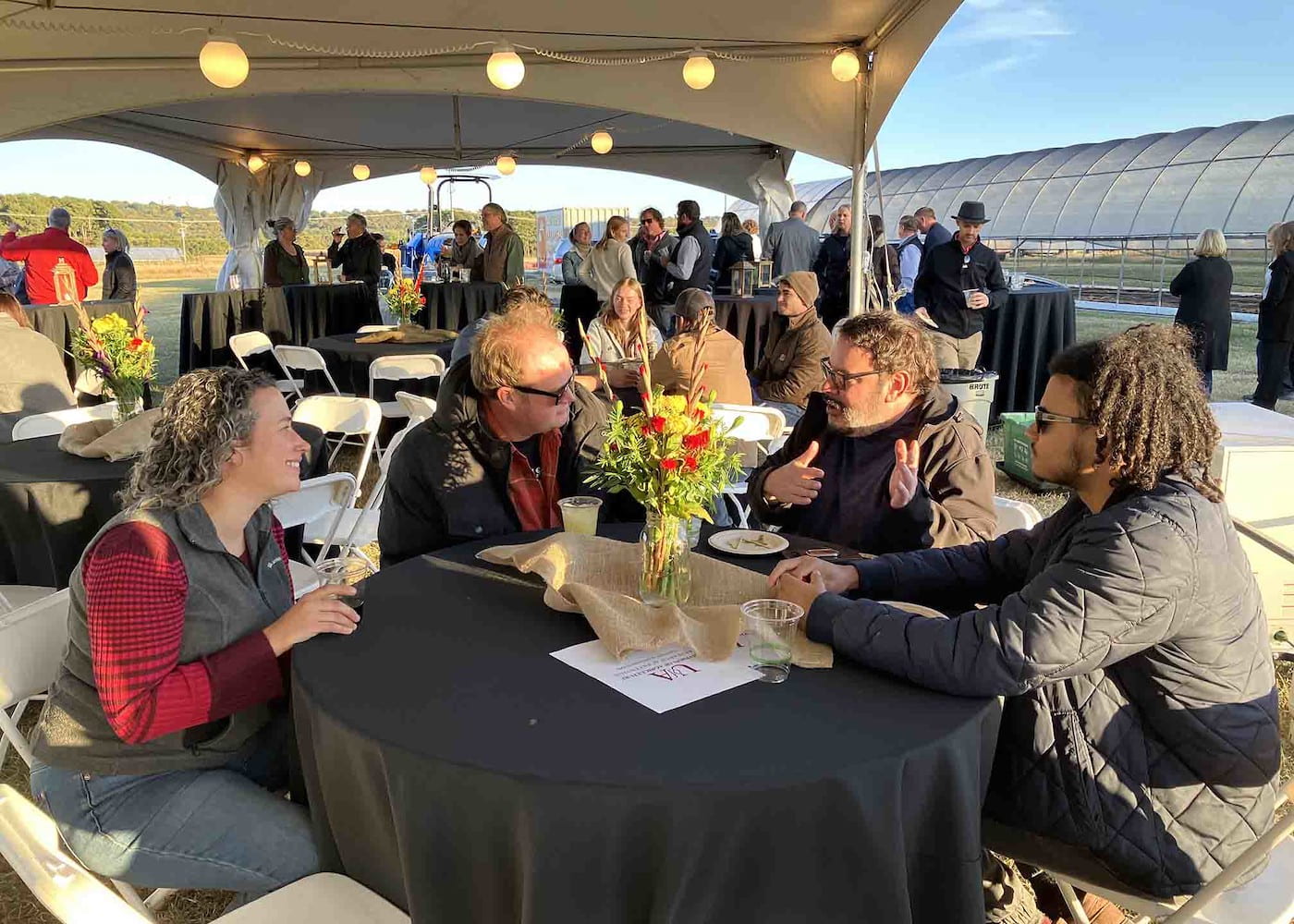 FARMERS FOR TOMORROW — Brian Foster, center left, of Sunny Acres Farms speaks with Farmers for Tomorrow fund supporters at the 2022 fundraising event.