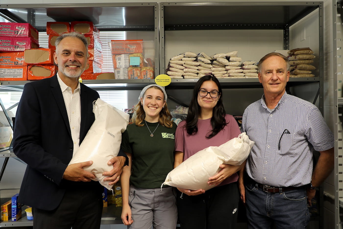 Arkansas Agricultural Experiment Station Director Jean-Francois Meullenet, left, and Assistant Director Nathan McKinney, right, joined student volunteers Katelyn Helberg and Caroline Wilson for the intake of rice donations to the Jane B. Gearhart Full Circle Food Pantry at the University of Arkansas.