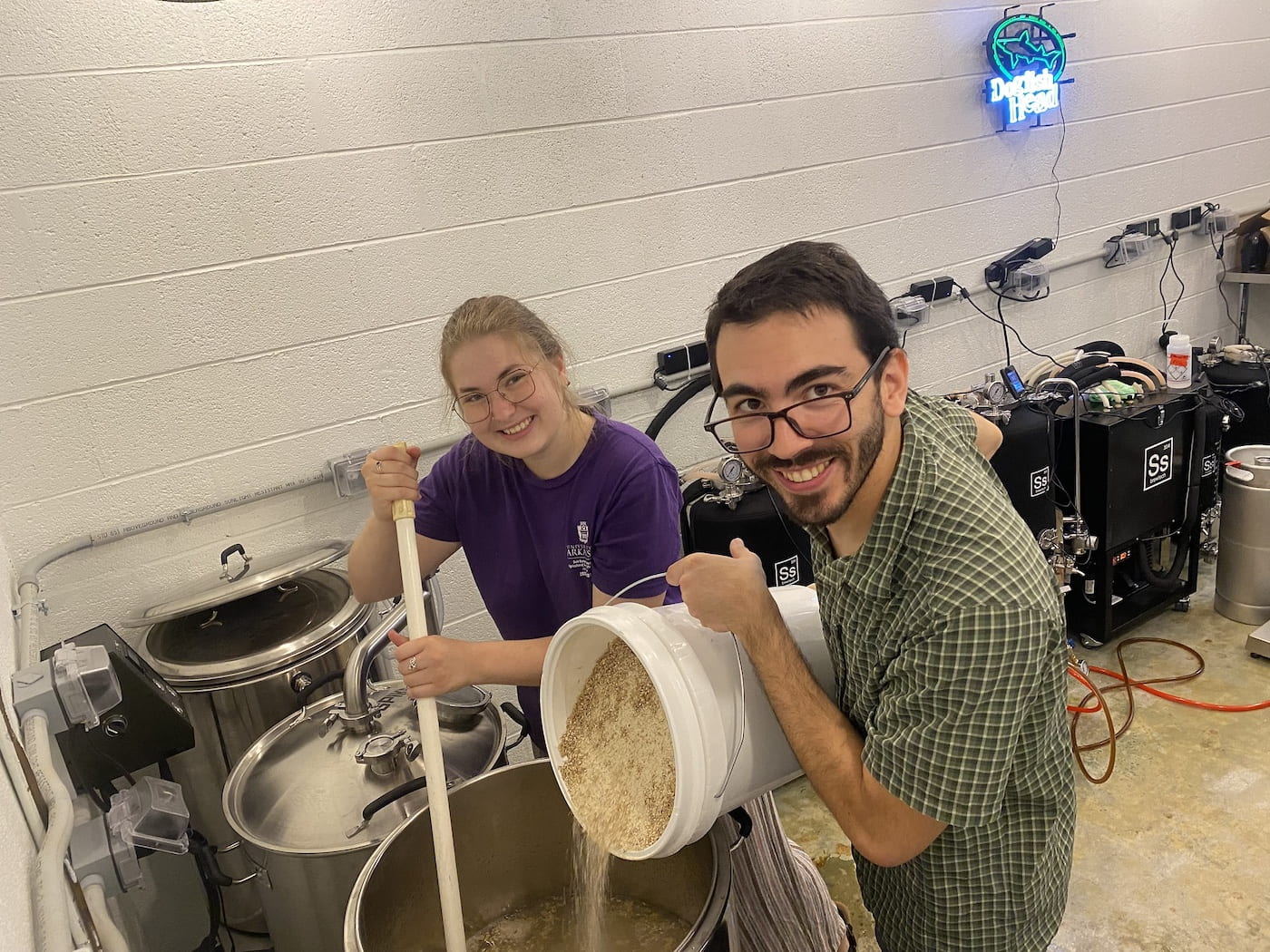 BREWING SCHOOL — Larissa Morley, left, a horticulture major, created the "Roasted Revelry Stout" oatmeal stout, and Bernardo Guimaraes, a doctoral food science student, created two IPA (India pale ale) beers as part of the new BREW 4573/5573 Beer Production and Analysis course. (U of A System Division of Agriculture photo)