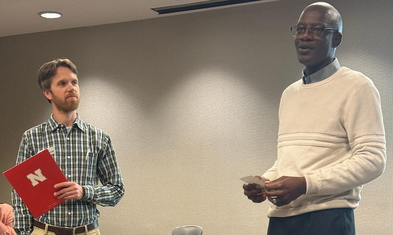 AWARD OF EXCELLENCE — Griffiths Atungulu, right, accepts the 2024 Andersons Cereal and Oilseeds Award of Excellence from Devin Rose with NC-213: The U.S. Quality Grains Research Consortium. (Courtesy photo)