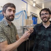 MALTED RICE — Scott Lafontaine, left, and Bernardo P. Guimaraes raise a glass of malted rice beer following a year-long study that investigated the suitability of rice for malting and brewing. (U of A System Division of Agriculture photo by Paden Johnson)