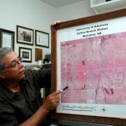 Claude Kennedy showing a map of the cotton research station. Taken Aug. 24, 2005. (U of A System Division of Agriculture file photo)