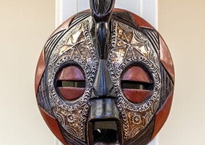 Hand-crafted Ghanaian mask, one of several African masks on display.