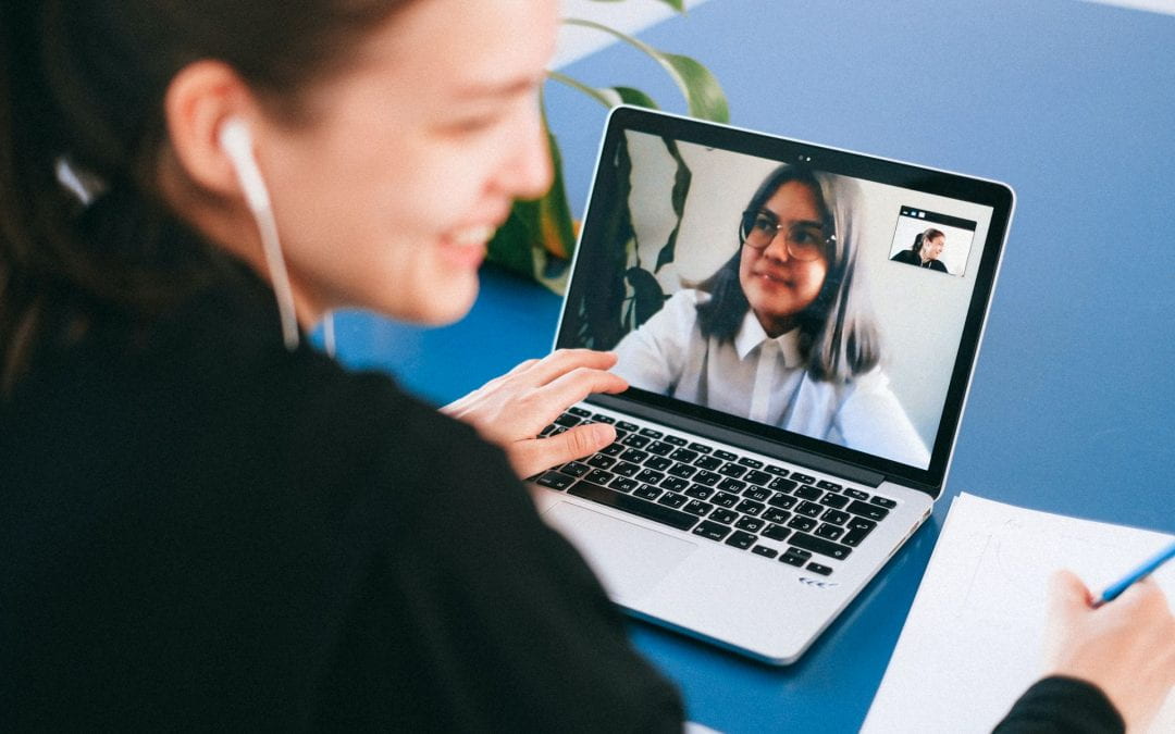 Female employee having a videoconference conversation with a colleague