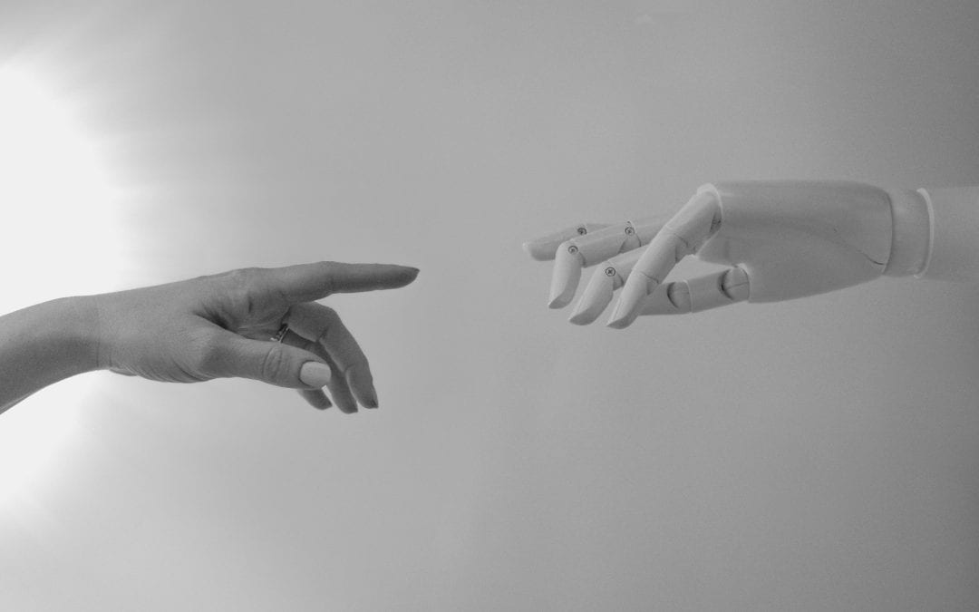 Black and white version of "Creation of Adam" by Michaelangelo with one hand human and other robotic