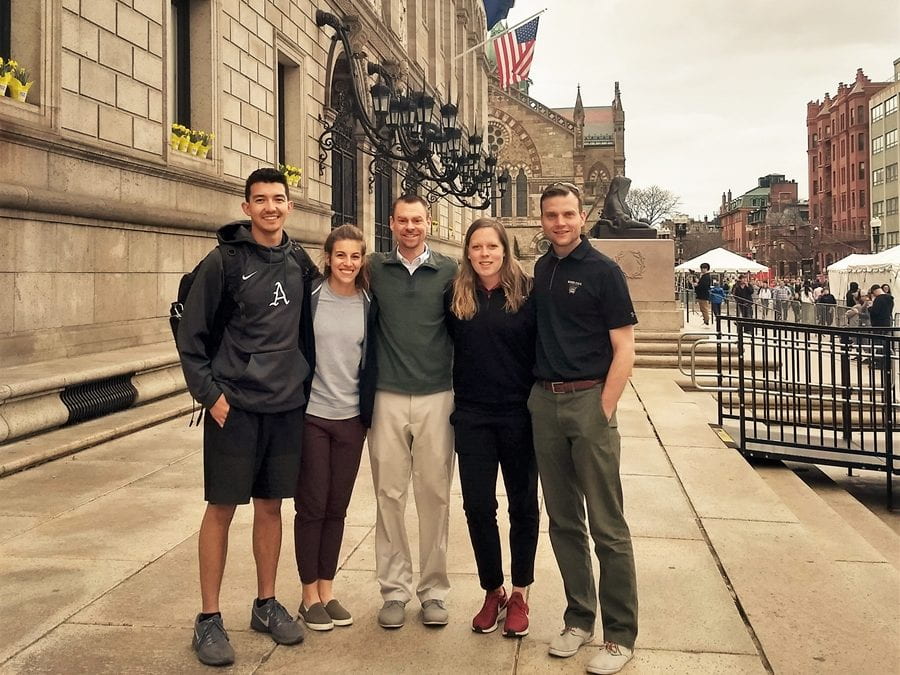 Associate professor Brendon McDermott (middle) with athletic training students at the 2019 Boston Marathon. McDermott has served as a heat illness expert and researcher on the race's medical team for many years.