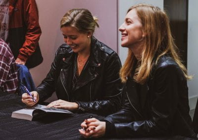 Jenn and Chessy signing books