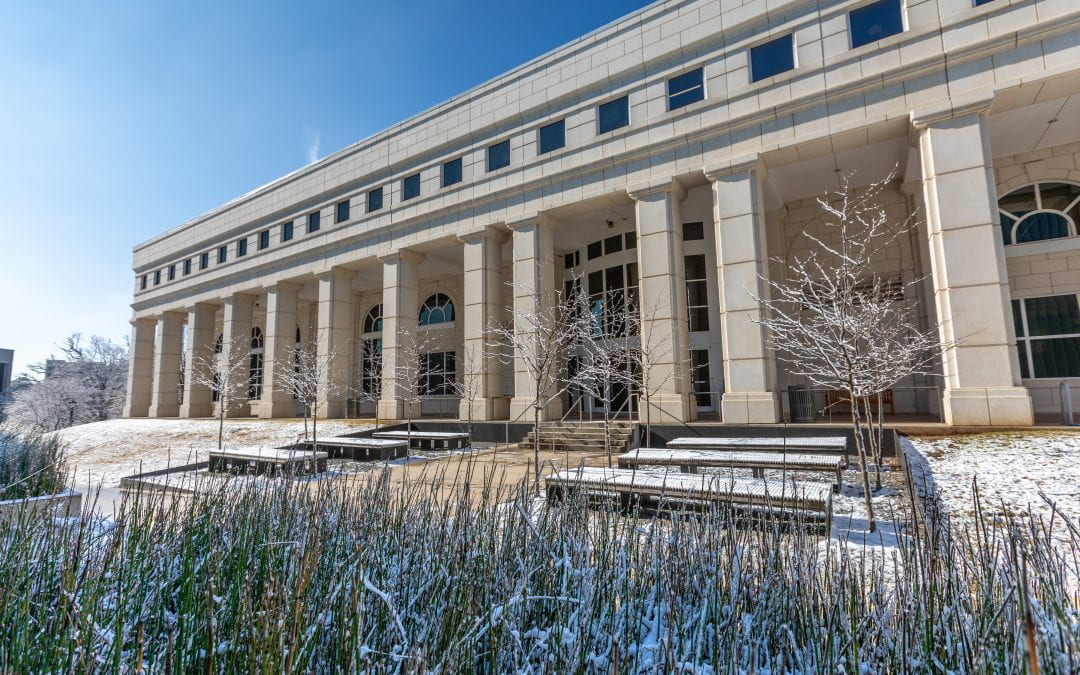 An image of the east side portico of Mullins Library in the snow.