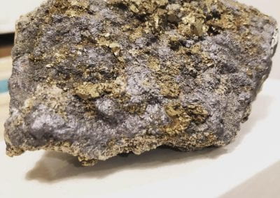 Rock with gold fragments from a museum's geology collection.