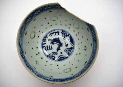 Cracked bowl with cobalt blue designs.